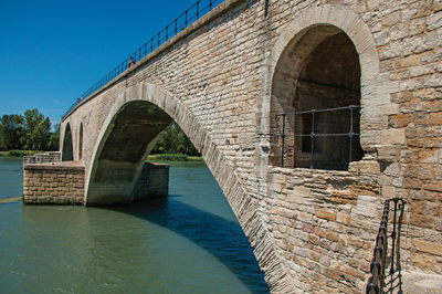 Arch bridge over canal against sky
