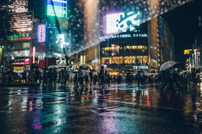 Crowd on wet street during rainy season at night