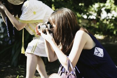 Women photographing on sunny day