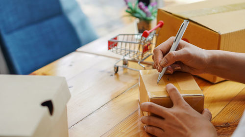 High angle view of woman holding hands on table