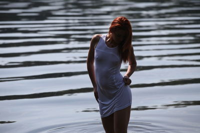 Young woman standing in lake