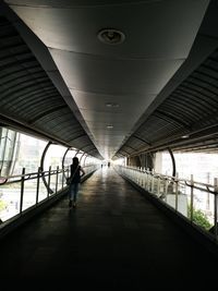 Rear view of people walking on footpath