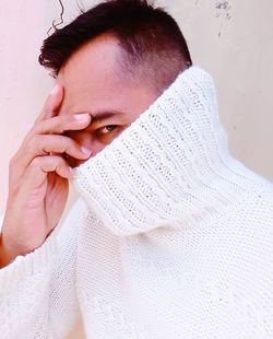 Close-up portrait of woman covering face