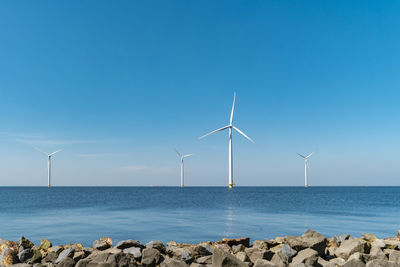 Windmills by sea against clear blue sky, windmills by sea against sky, windmills park westermeerdijk