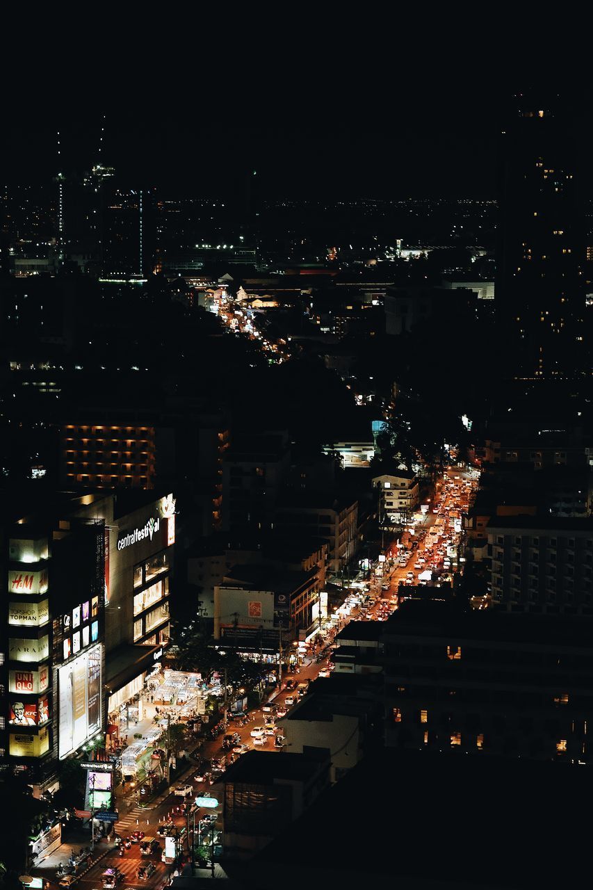 HIGH ANGLE VIEW OF ILLUMINATED CITY BUILDINGS AT NIGHT