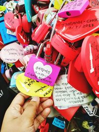 Close-up of hand holding love locks