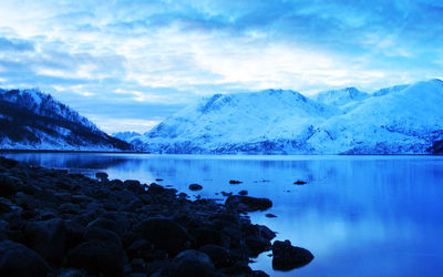 Scenic view of lake with mountains in background