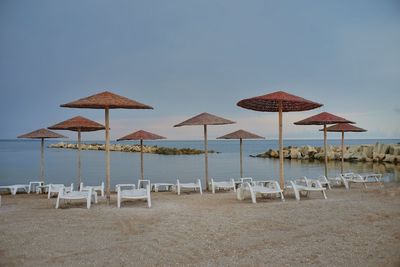 Umbrellas on beach against sky