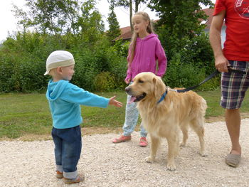 Rear view of people with dog