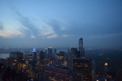 Illuminated cityscape against sky at night