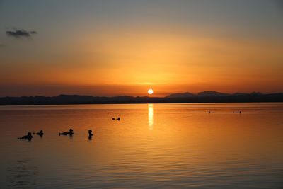 Scenic view of lake against sky during sunset