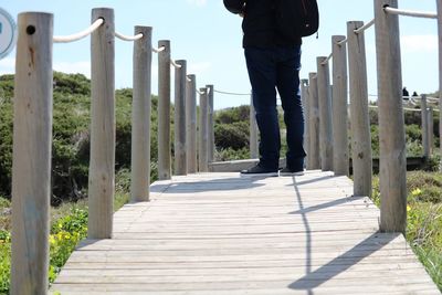 Low section of man standing on footpath