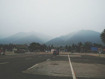 Empty road leading towards mountains