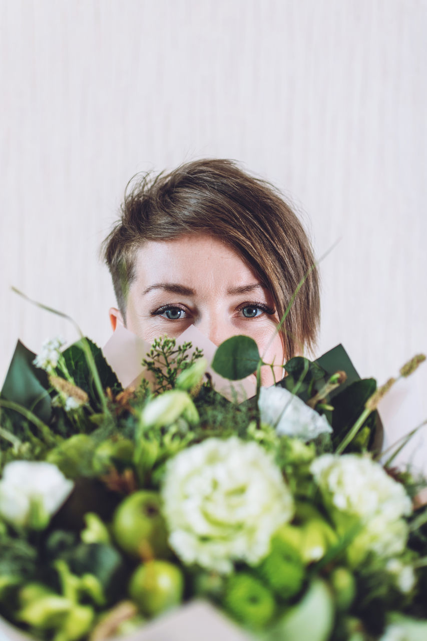 PORTRAIT OF YOUNG WOMAN WITH VEGETABLES IN PLANT