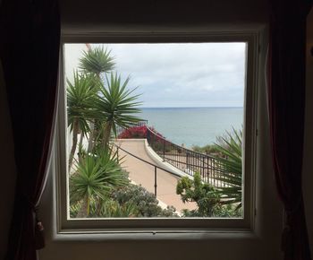 Patio and sea seen through window