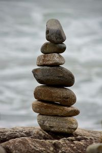 Stack of stones on rock in sea