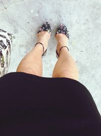 Low section of woman standing on tiled floor