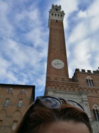 Low angle view of clock tower against sky