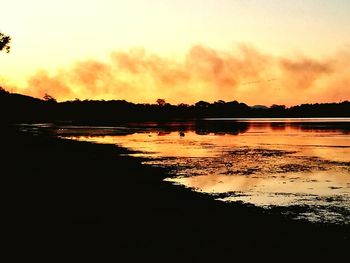 Scenic view of lake against sky during sunset