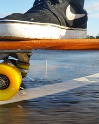 Close-up of yellow wheel in water