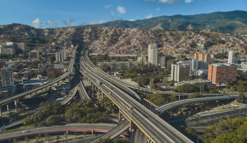 High angle view of light trails on highway in city against sky