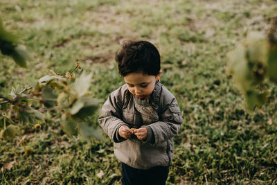 Side view of boy standing on field