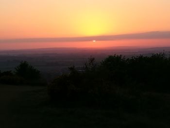 Scenic view of sea against orange sky