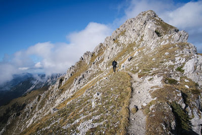 Full length of woman walking on mountain ridge