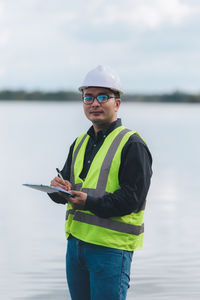 Portrait of young man holding umbrella