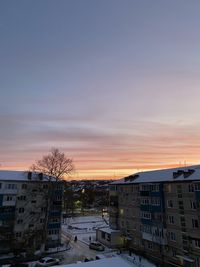 Buildings against sky during sunset