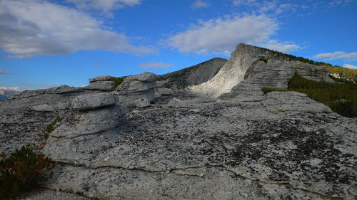 Low angle view of rock formations against sky