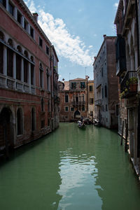 Canal passing through buildings in city of venice italy