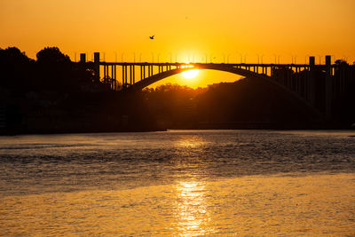 Beauiful orange sunset over the duoro river in porto city