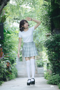 Student wearing school uniform while standing in park