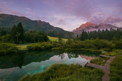 Scenic view of lake and mountains against sky