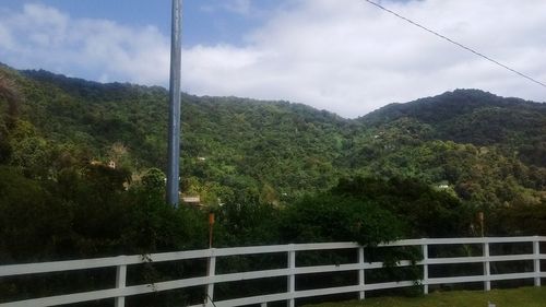 Scenic view of mountains against cloudy sky