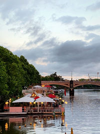 Scenic view of river by building against sky