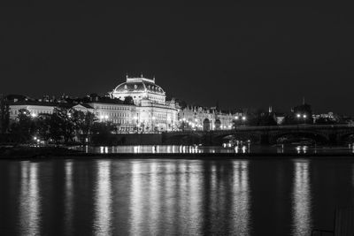 Illuminated city against sky at night