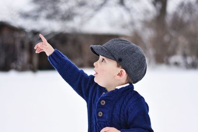 Close-up of boy with ice cream in winter