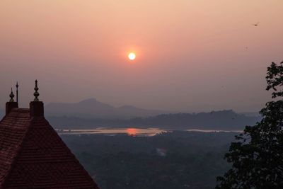 Scenic view of silhouette mountains against sky during sunset