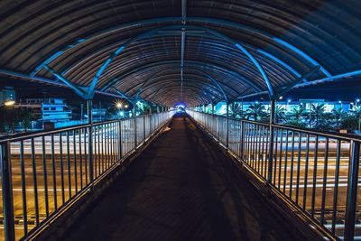 Illuminated footbridge at night