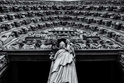 Low angle view of statue of virgin mary and jesus christ on church wall