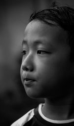 Close-up portrait of cute boy looking away
