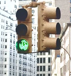 Low angle view of road signal against buildings