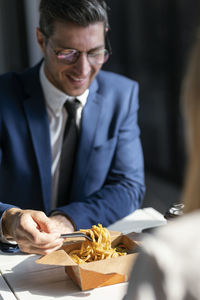 Midsection of man eating food