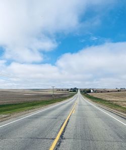 Empty road along countryside landscape