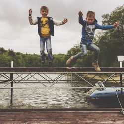 Full length of girl playing with arms raised