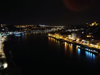 Illuminated cityscape against sky at night