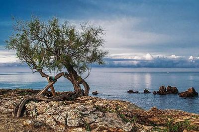 Scenic view of sea against cloudy sky