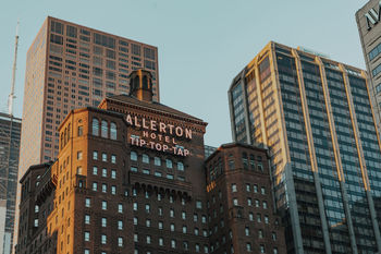 LOW ANGLE VIEW OF OFFICE BUILDINGS AGAINST SKY